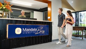 A reception desk with a sign reading 'Mandala Signature Berry.'