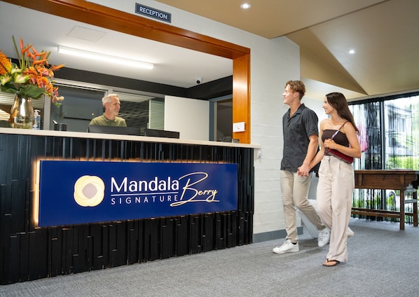 A reception desk with a sign reading 'Mandala Signature Berry.' - Mandala Signature Berry (Berry)