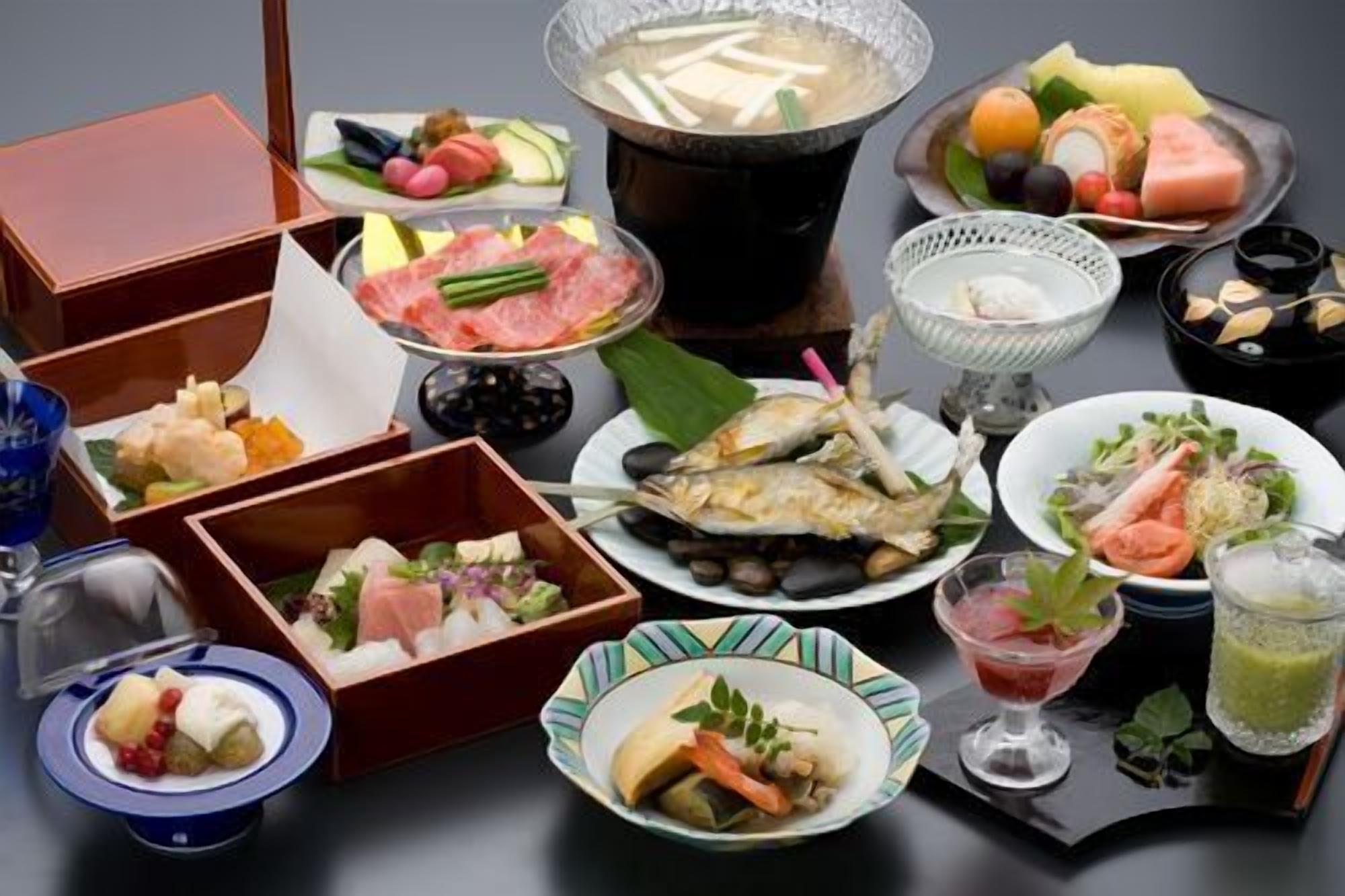 A variety of Japanese dishes, including sushi, sashimi, and a hot pot.