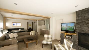 A modern living room with a sofa, armchairs, a coffee table, a TV, and a fireplace.