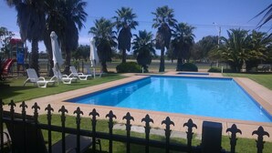 A rectangular swimming pool with a tiled edge, surrounded by a low fence with decorative posts. - Koonwarra Holiday Park (Lakes Entrance)