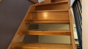 A wooden staircase with a handrail and a landing. - Koonwarra Holiday Park (Lakes Entrance)