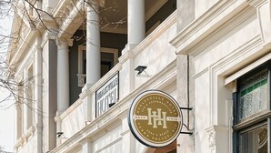 A historic building with a sign for the Herleville Hotel, featuring a classic architectural style with columns and a prominent entrance.