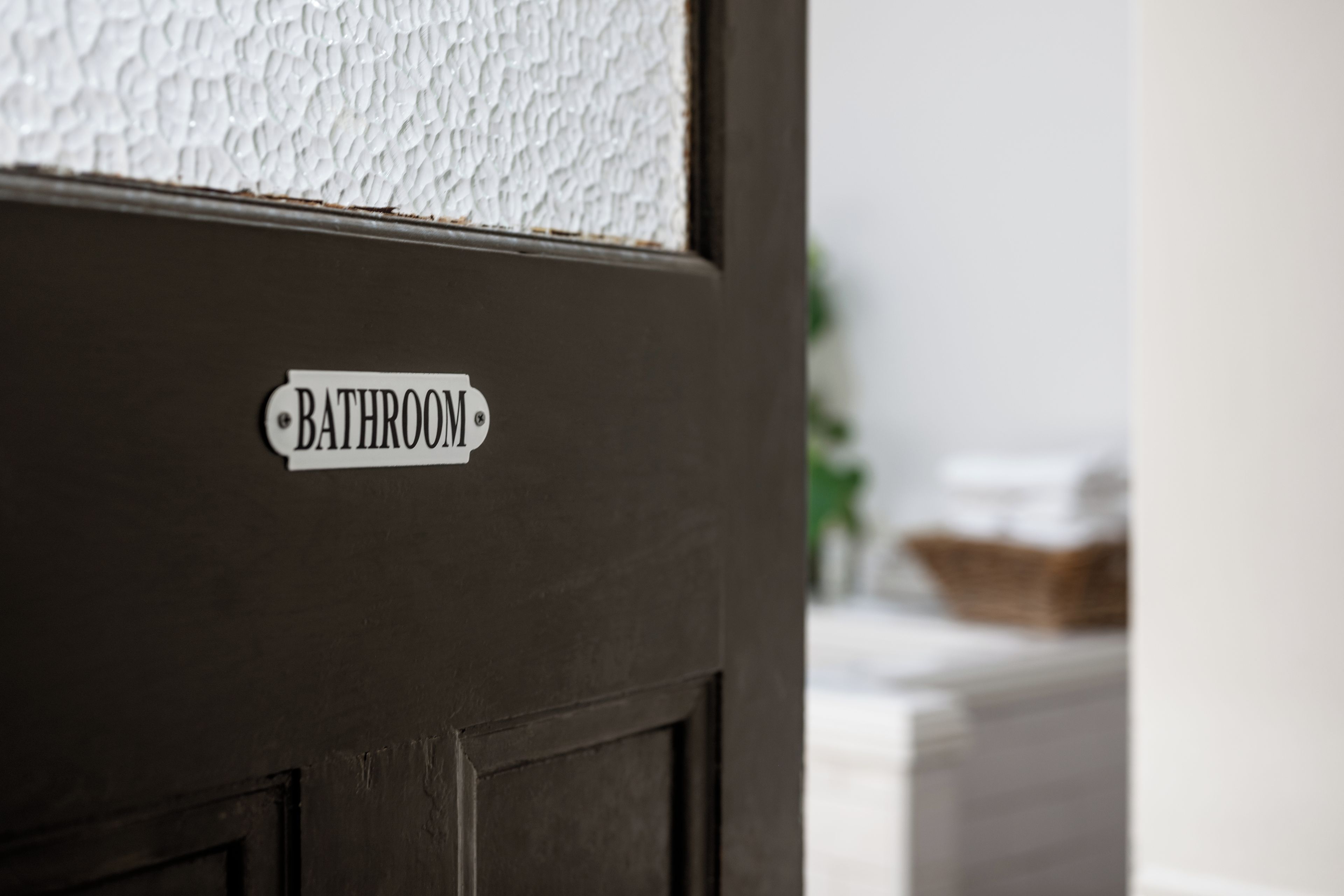 A door with a sign that reads 'BATHROOM'.