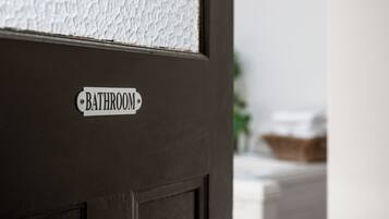 A door with a sign that reads 'BATHROOM'.