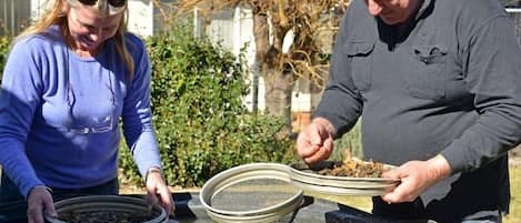 Two people near a water filtration system outdoors.