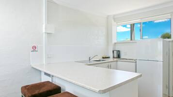 Full-sized fridge, microwave, stovetop, coffee/tea maker