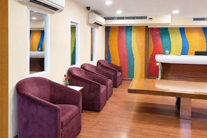 A room with purple chairs, a wooden table, and a colorful wall. - Hip Bangkok (Bangkok)