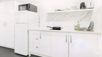 Full-size fridge, microwave, stovetop, coffee/tea maker