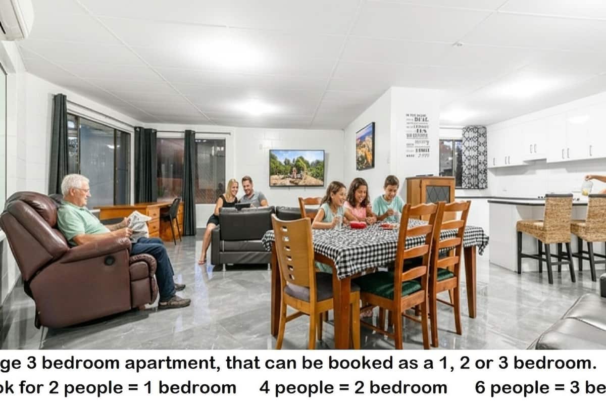 A large 3-bedroom apartment with a dining area, kitchen, and living room. It can be booked for 1, 2, or 3 people.