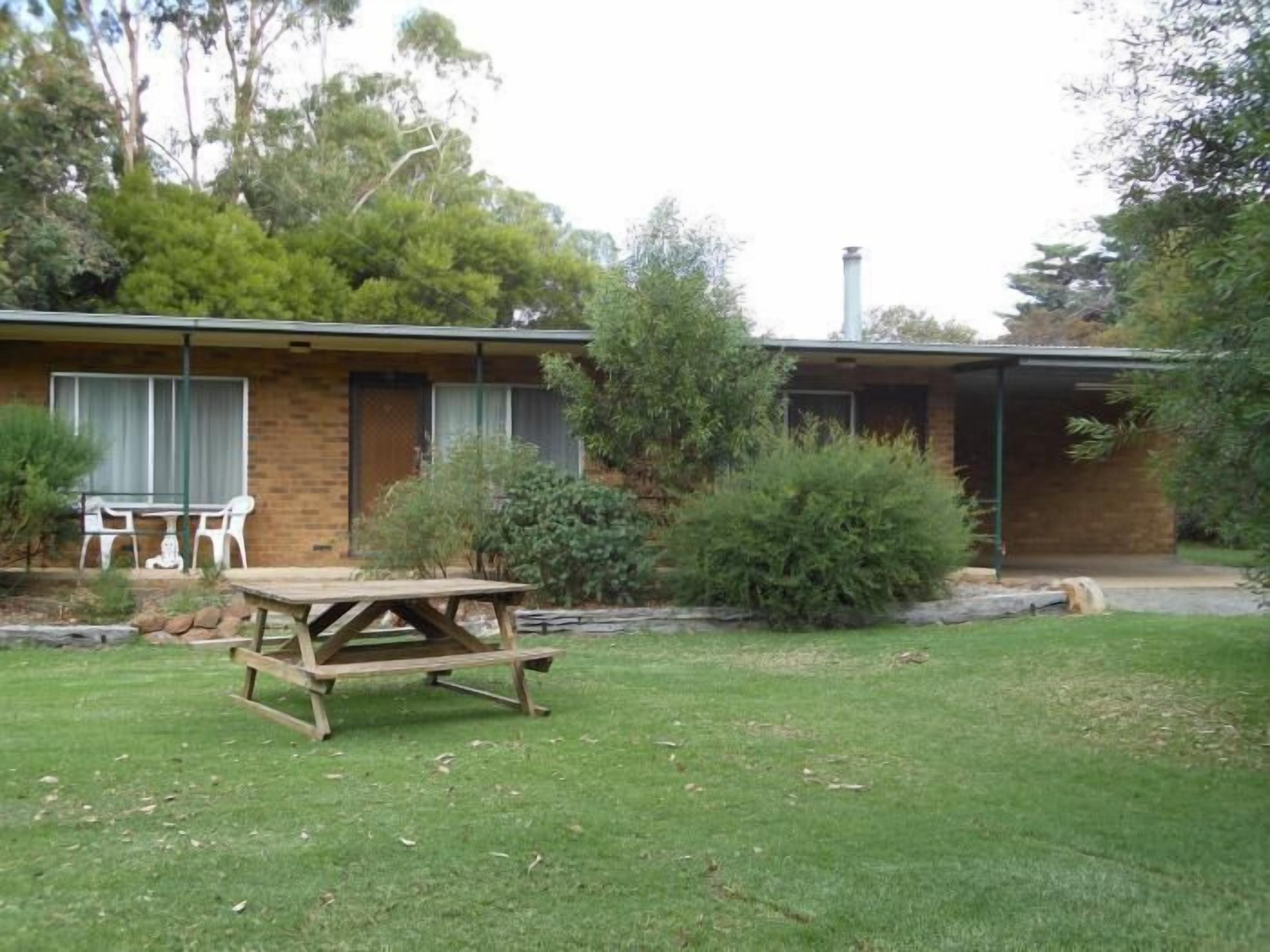 A single-story brick house with a covered patio area.
