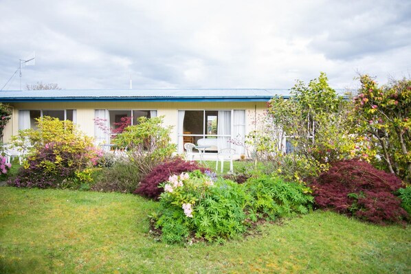 A single-story house with a blue roof and a front porch.