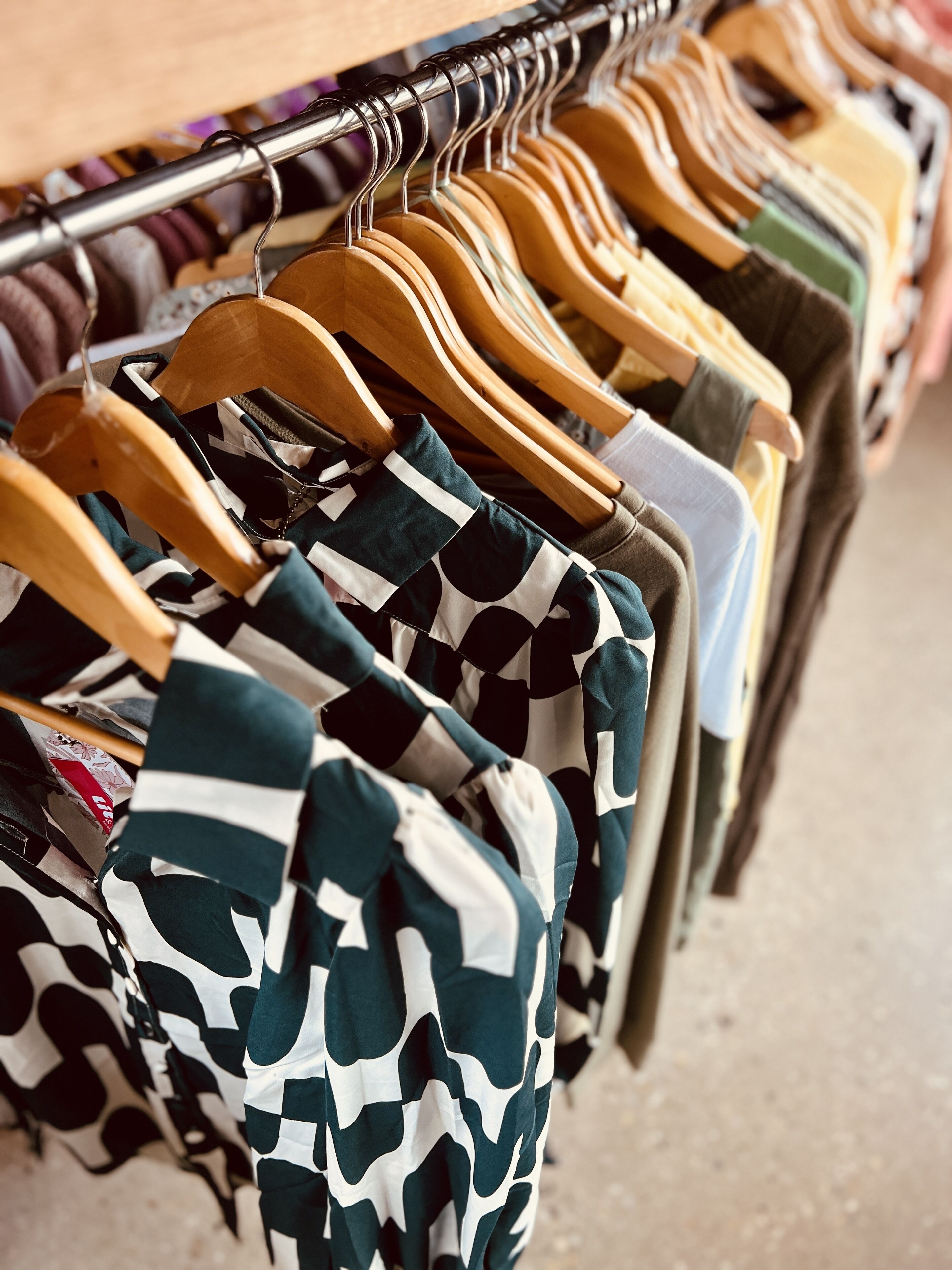 A clothing rack with various garments.