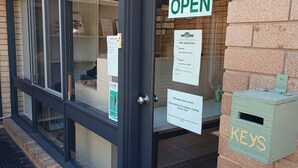 A building entrance with a glass door, a sign indicating 'OPEN', and a 'KEYS' box on the wall. - Lithgow Tourist and Van Park (Bowenfels)
