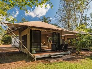 A small, single-story structure with a covered patio area, a visible staircase, and a small outdoor seating area. - BIG4 Howard Springs Holiday Park (Howard Springs)