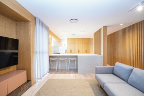 Three Bedroom Premium Water Front | Living area | 40-inch flat-screen TV with cable channels, TV - Munna Beach Apartments (Noosaville)