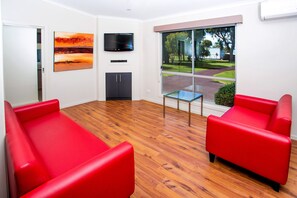 2 Bedroom Cabin - Albatross | Living area | Flat-screen TV, DVD player - BIG4 Port Fairy (Port Fairy)