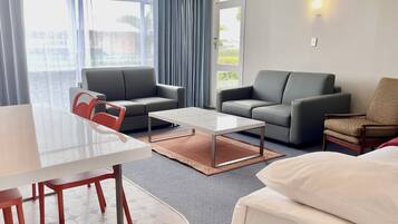 Deluxe Suite, 3 Bedrooms | Living room | Flat-screen TV