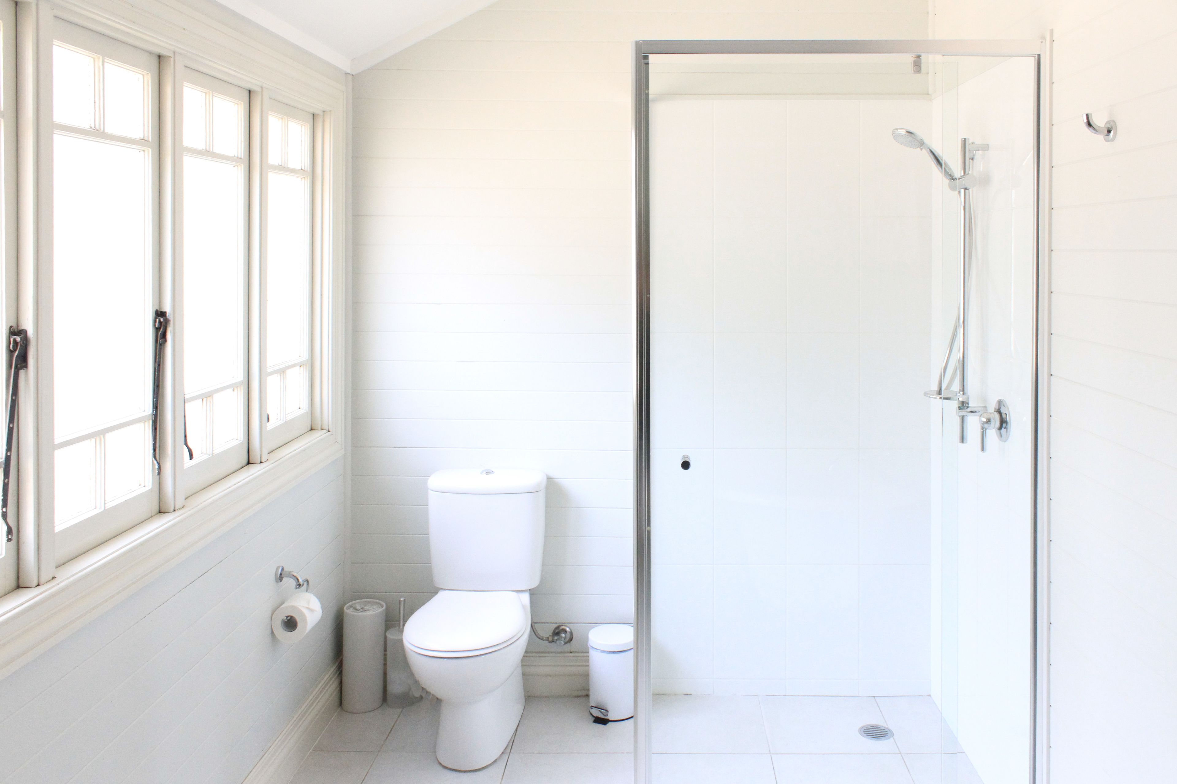 A bathroom with a toilet, bidet, and shower.