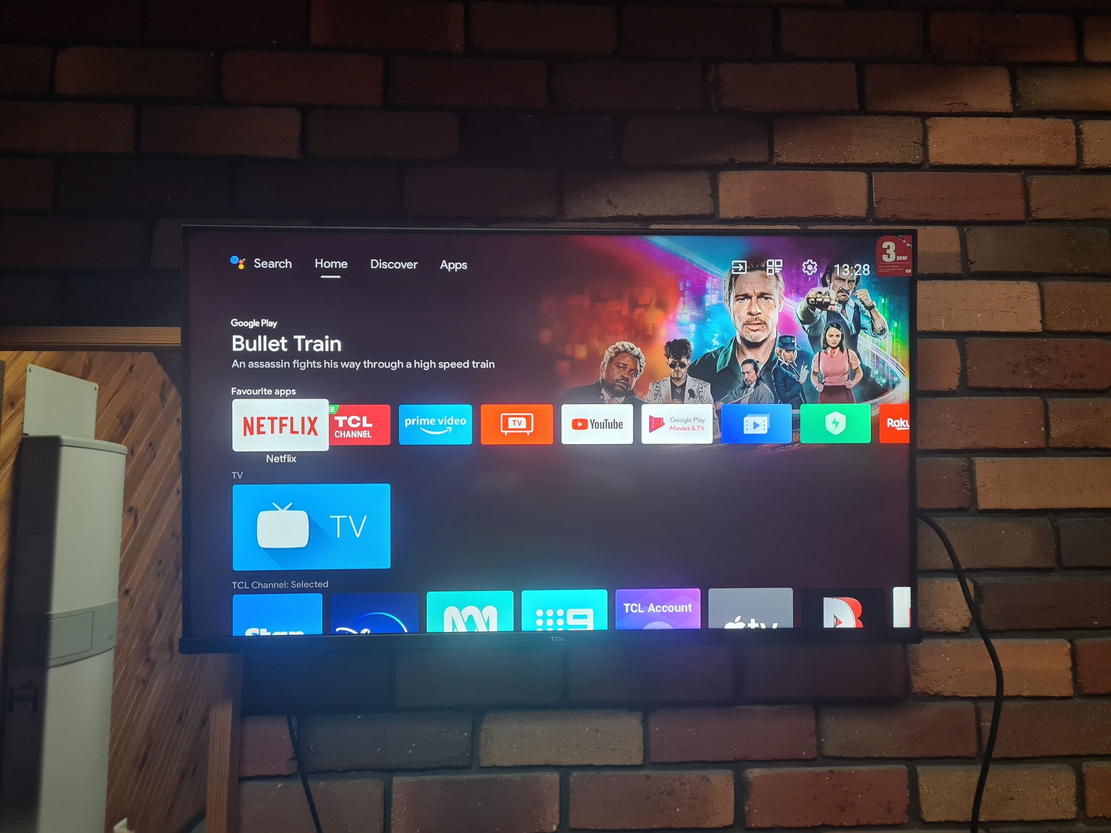 A television screen displaying a Google Play Store interface with various app icons and a movie title.