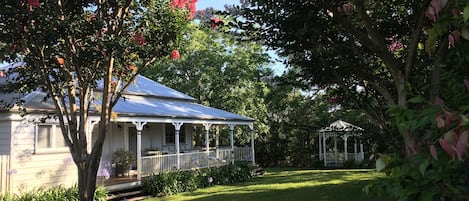 A house with a covered porch and a garden.
