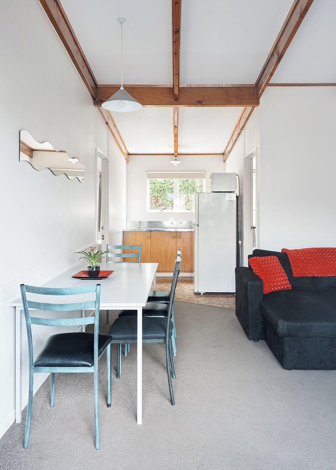 A compact living space with a dining area, kitchen, and seating area.