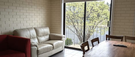 Apartment, 2 Bedrooms (Upstairs) | Living area | Flat-screen TV