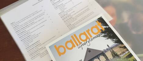 A menu with breakfast options and a magazine cover.