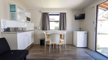 Kitchen Cabin (No Linen Supplied) | Living area | 22-inch flat-screen TV with satellite channels, TV, books