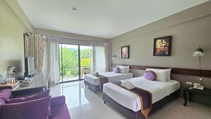 A hotel room with two beds, a desk with a chair, a balcony with curtains, and a painting on the wall. - Poonyamantra Resort Chiang Rai (Mae Sai)