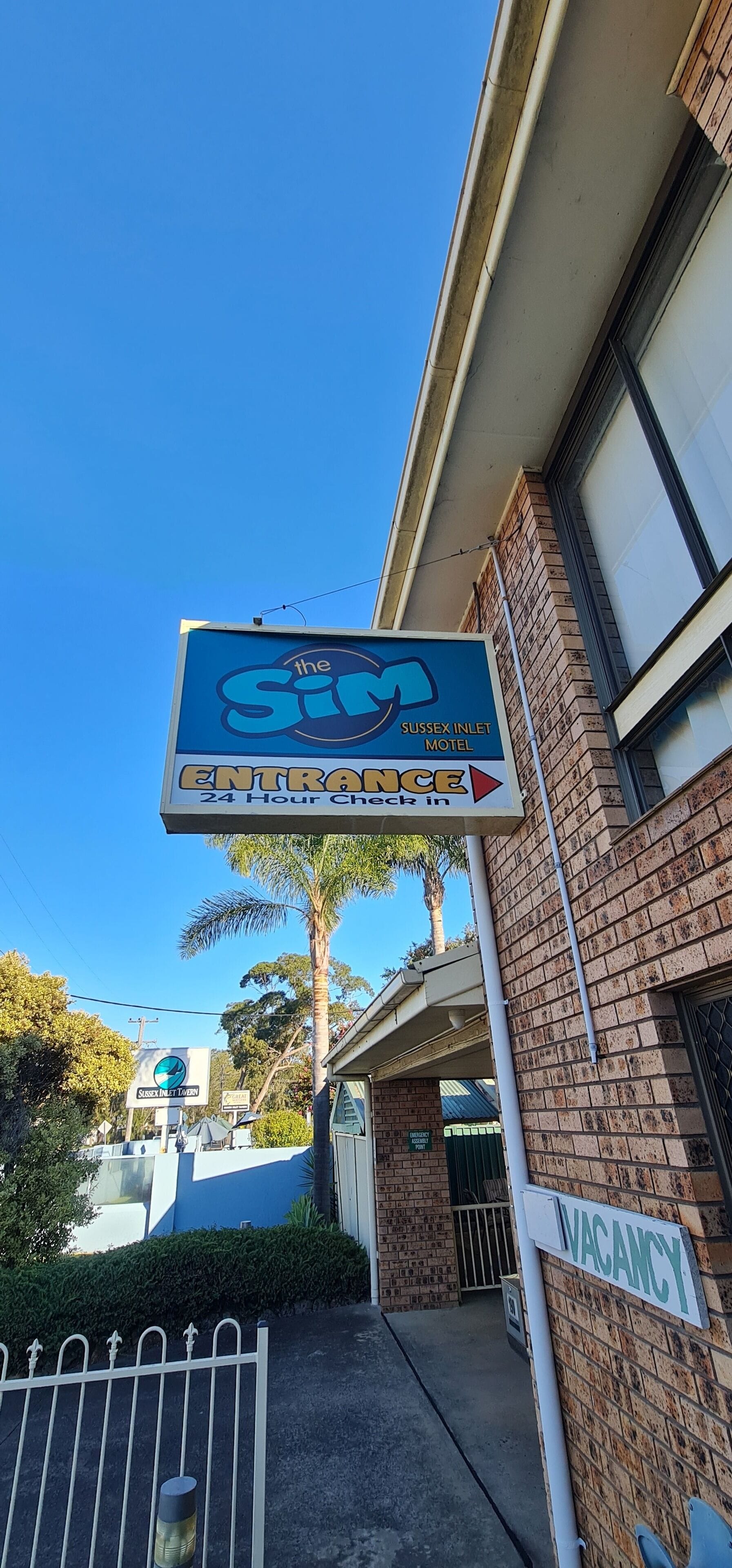 Un panneau indiquant le « Sussex Inlet Motel » avec une mention précisant que l’enregistrement est possible 24 heures sur 24.