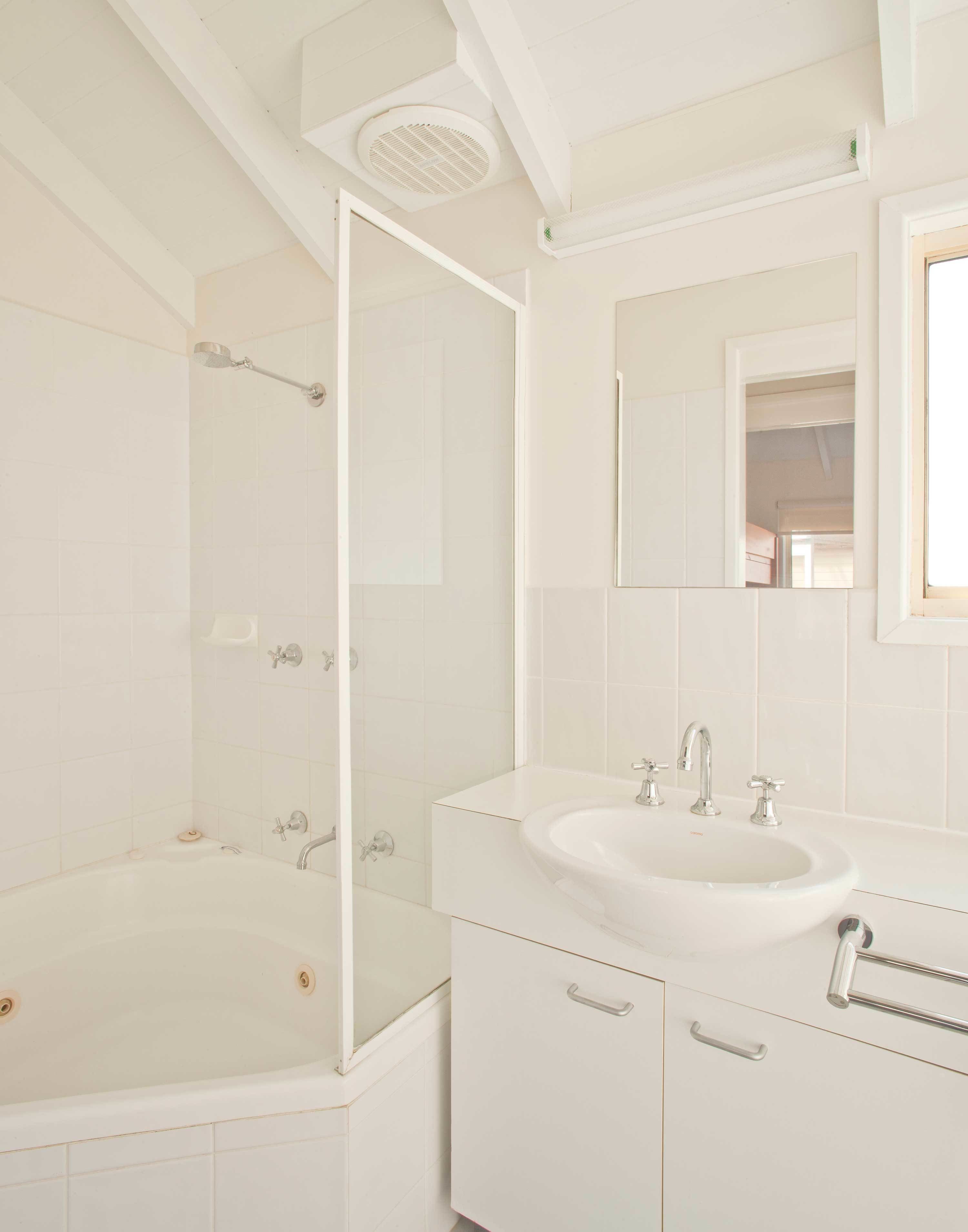 A bathroom with a bathtub, a sink, and a shower.