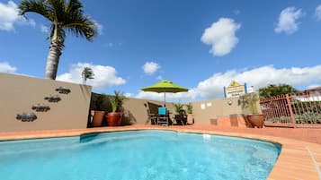 Outdoor pool, open 7:00 AM to 7:00 PM, pool loungers