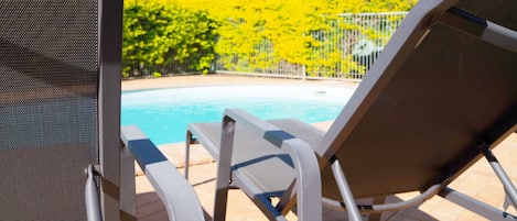 Outdoor pool, open 7:00 AM to 9:00 PM, pool umbrellas, sun loungers