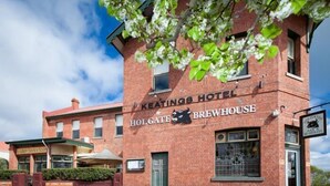A brick building with a sign reading "Keating's Hotel" and "Holgate Brewery" on the facade.