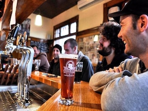 A bar with a tap and a glass of beer. - Holgate Brewhouse At Keatings Hotel (Woodend)