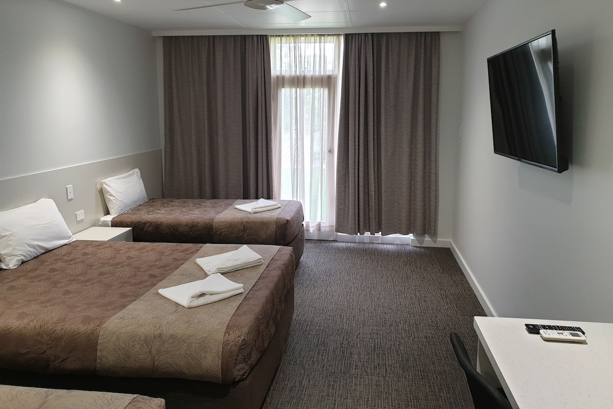 Desk, iron/ironing board, bed sheets