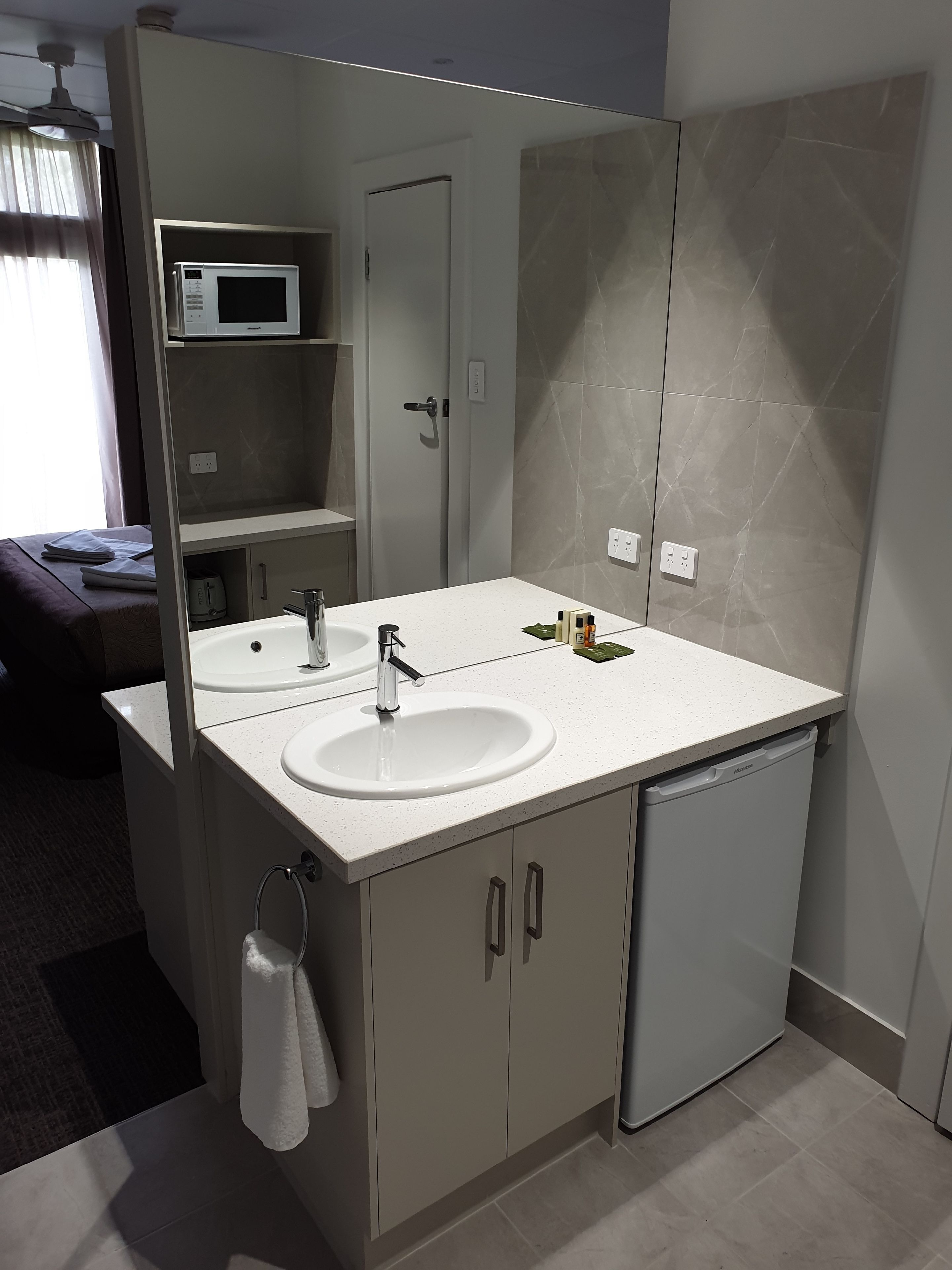 Desk, iron/ironing board, bed sheets