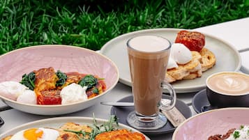 A table set with various breakfast dishes, including eggs, toast, and coffee.