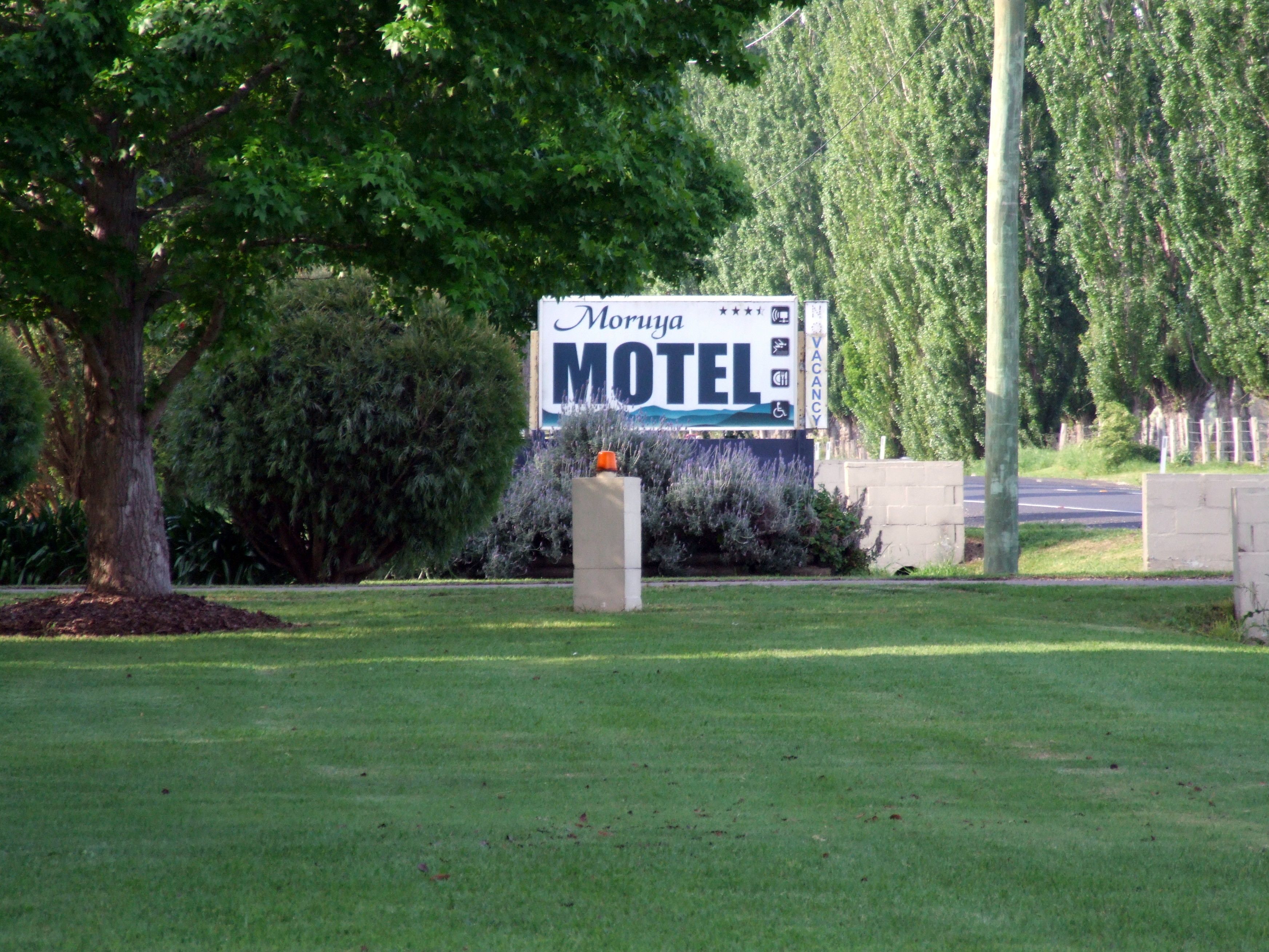 Een motelbord met een 'VACANCY'-symbool en een rolstoeltoegankelijkheidsicoon.