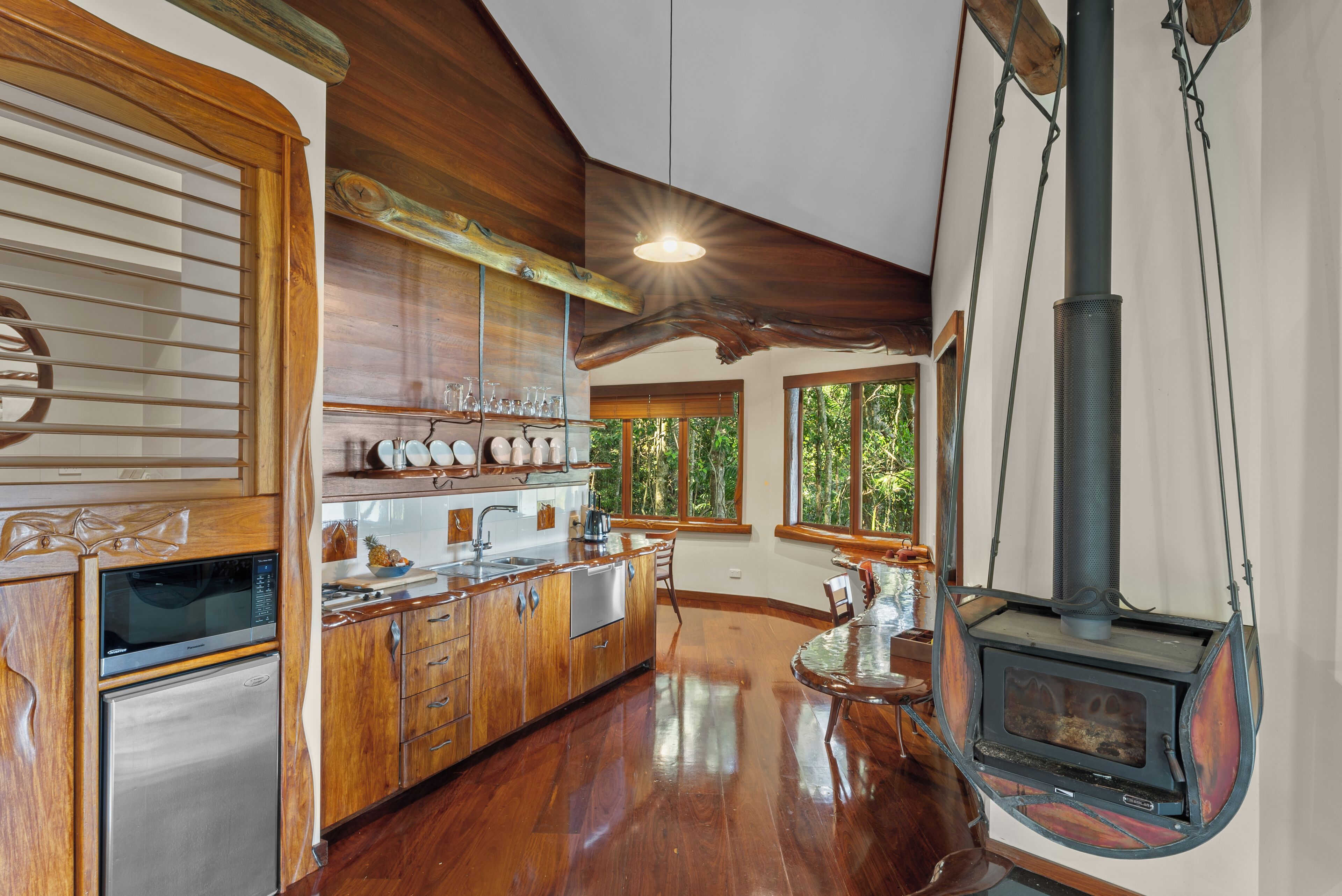 A spacious kitchen with wooden cabinets, a built-in microwave, and a large stove.