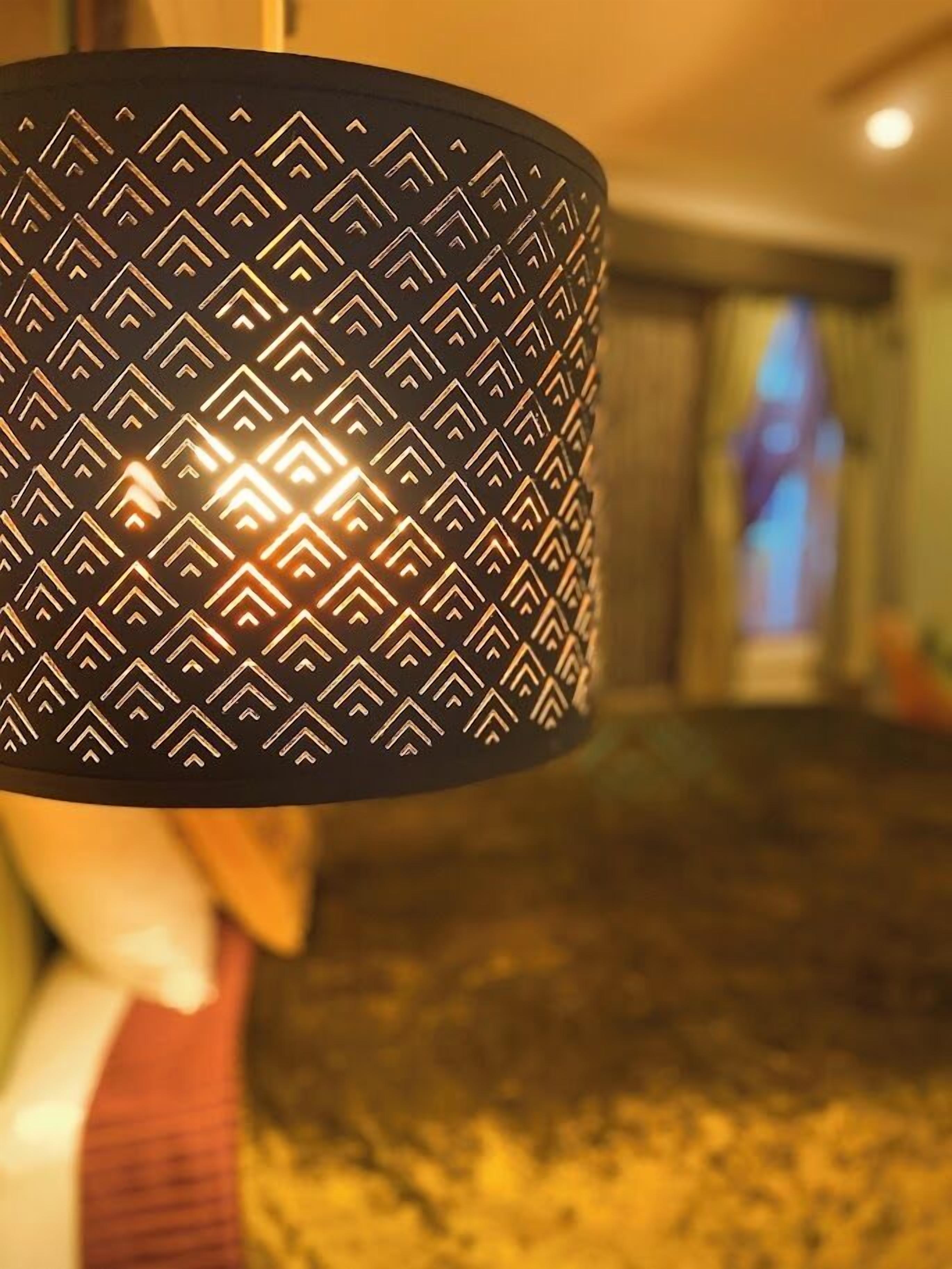 A close-up of a patterned lamp with a geometric design.
