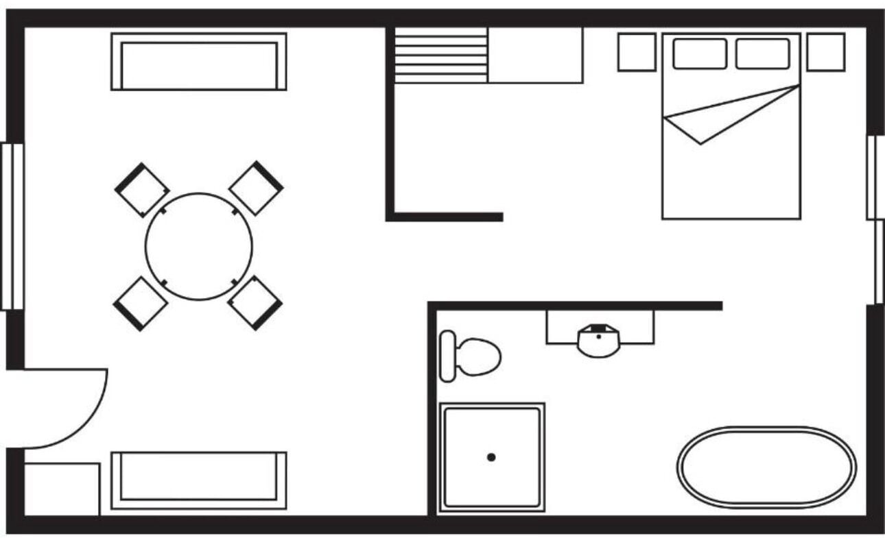 Un plan d’étage comprenant une salle à manger centrale, une cuisine, une salle de bain et un petit espace de vie.