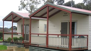 A two-story mobile home with a porch and a covered deck area. - Warrnambool Motel and Holiday Park (Warrnambool)