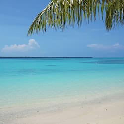 On the beach, white sand, sun-loungers, beach towels