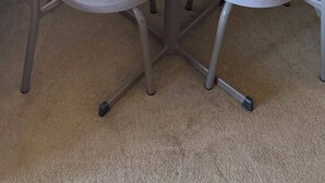 A small dining table with two chairs, a wooden table top, and a carpeted floor. - Deniliquin Country Club Motor Inn (Deniliquin)