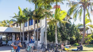 A building with a white facade, multiple windows, and a covered entrance. - YHA Coolangatta Gold Coast (Bilinga)