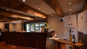 A bar area with a wooden counter, a wine display, and a sign reading "Talisman Small Producer of the Year". - Evedon Park Bush Retreat (Burekup)
