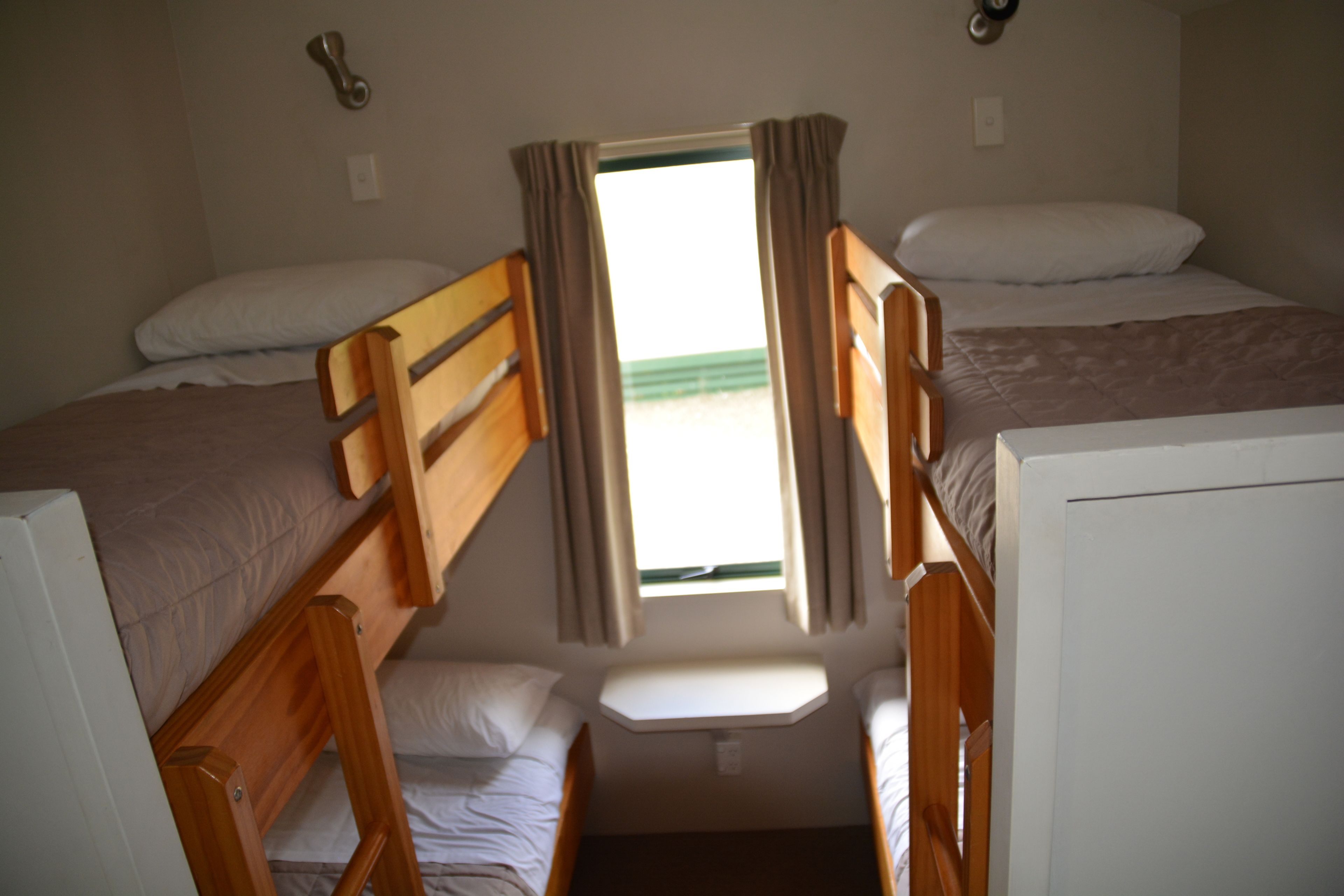 A compact room with bunk beds and a small window.