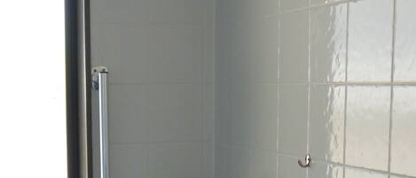A bathroom with a toilet, sink, and window.